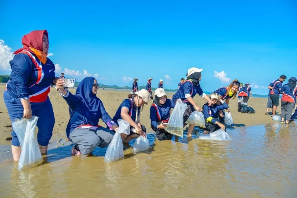 DreamTeam Adventures Group releasing bags of fish into the sea during an Eco-Olympics team building program.